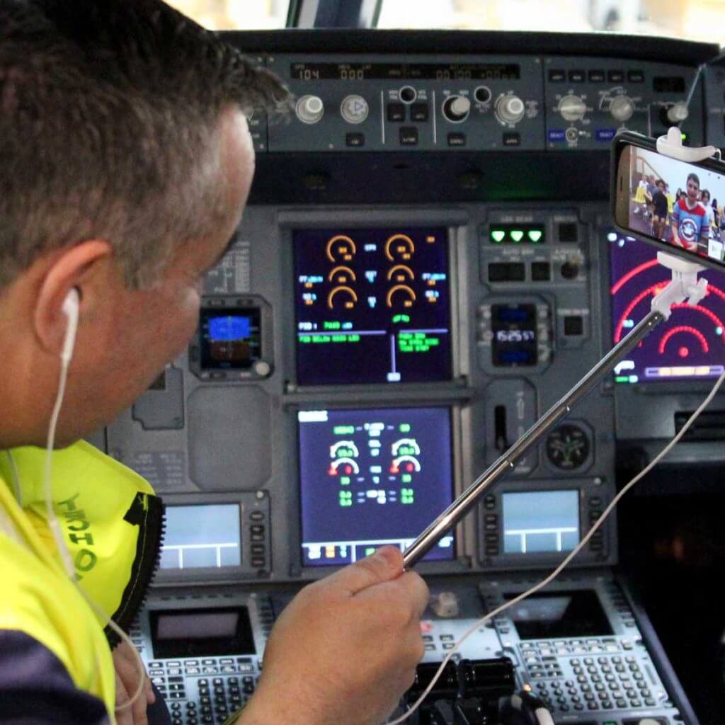 Jet Blue pilot talking to students from cockpit